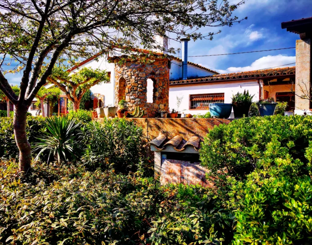 Façana il·luminada de la masia tradicional Can Micós a Girona, ideal per a lloguer íntegre de grups grans al peu del Montseny.